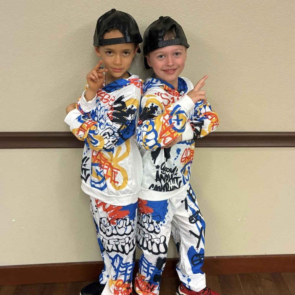 Two boys in matching graffiti-print hip hop outfits